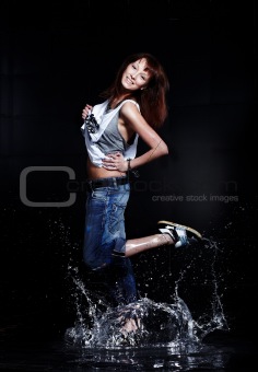 Cute Young woman dancing in water