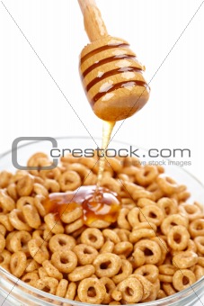 Pouring honey on cornflakes