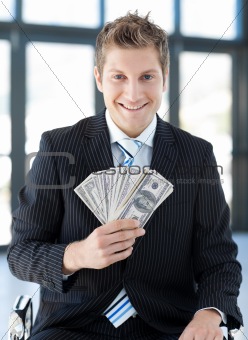 Businessman holding dollars