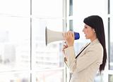 Businesswoman shouting in a megaphone