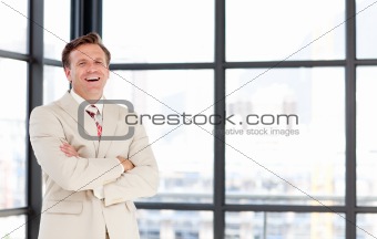 Smiling senior businessman with folded arms