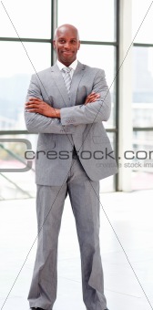 Smiling businessman with folded arms 