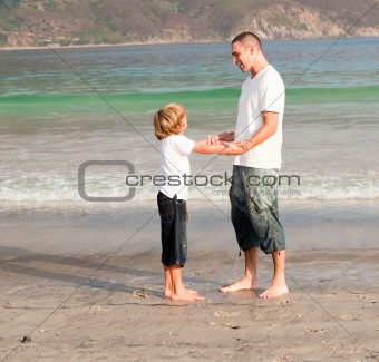 Father and son playing on a beach