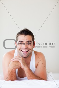 Man in bed smiling to the camera 