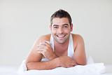 Man having a cup of coffee in bed
