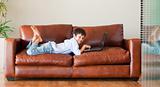 Young kid with a laptop on the couch