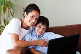 Mother and son playing with a laptop