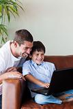 Father and son playing with a computer