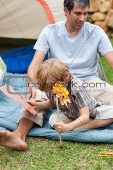 Father and son planting a flower