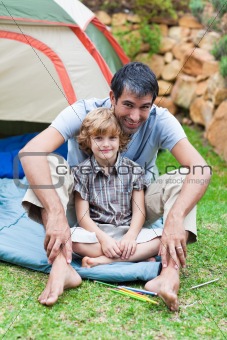 Father and son playing in a tent