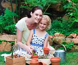 Mother and daughter planting in their garden