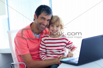 Father and son playing with a laptop