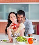 Couple eating and drinking in the kitchen