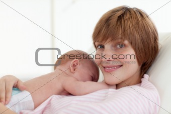 Mother embracing her newborn baby