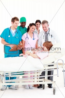 Doctors attending to a mother and her newborn baby