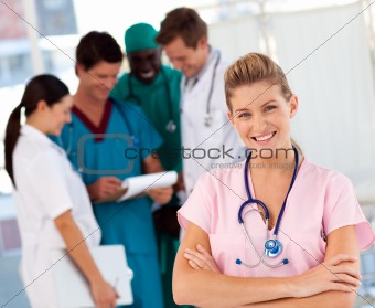 Nurse with doctors in the background