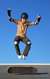 Boy Jumping High from Skateboard
