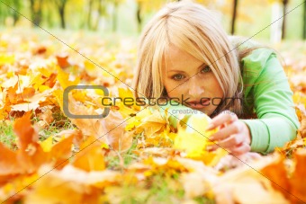Girl lying in leaves