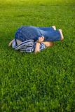 Boy lies on a grass