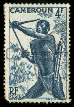 Vintage stamp from Cameroon depicting a tribal hunter