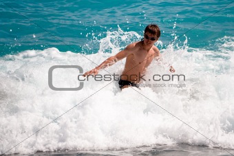 Young man in the ocean waves