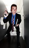 happy businessman standing in restroom