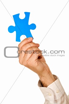 Businessman holding a piece of puzzle