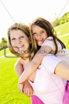 Mother and daughter piggyback