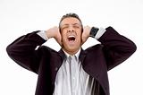 front view of shouting businessman putting hands on his ears