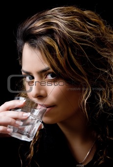 close view of beautiful model drinking water