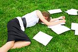 Business woman lying on the grass