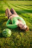 pregnantt woman on grass with melon