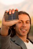 Handsome young man with small solar panel