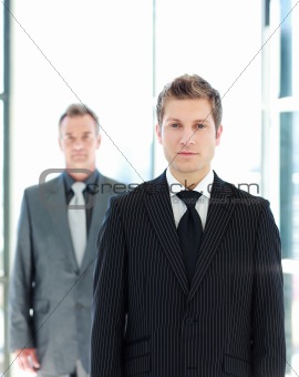 Young businessman standing in front of the camera