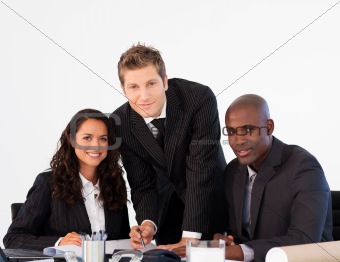 Business team in a meeting looking at the camera