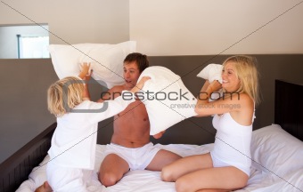 Family playing with pillows