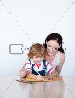 Mother helping her son to draw