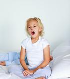 Beautiful daughter yawning in bed 