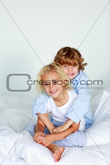 Brother embracing her sister in bed