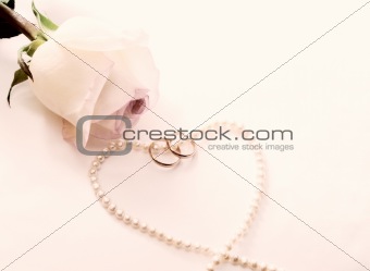 Rose, wedding rings, perl necklace
