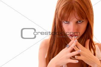 Beautiful serious woman with crossed fingers isolated on white