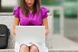 businesswoman using laptop outdoors