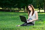 student with laptop outdoors