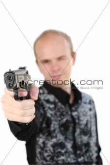Young man aiming with pistol in hand