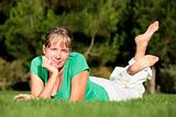 Woman relaxing on a lawn with a nice defocused background