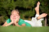 Woman relaxing on a lawn with a nice defocused background