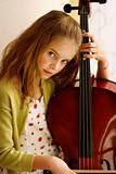 Close-up portrait of a pretty young girl with a cello.