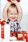 Little girl gleefully opening Christmas gifts.