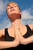Woman Meditating with Blue Sky