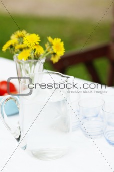 Jug of water and glasses on a table.